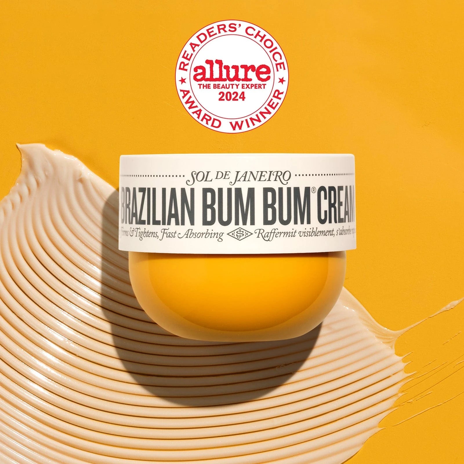 This image is of Sol de Janeiro Brazilian Bum Bum Cream. It is of a yellow background, the same color as Brazilian Bum Bum Cream with an Allure award on it as well as goop shot of the cream.
The text on the image reads as follows: allure 2024 the beauty expert
