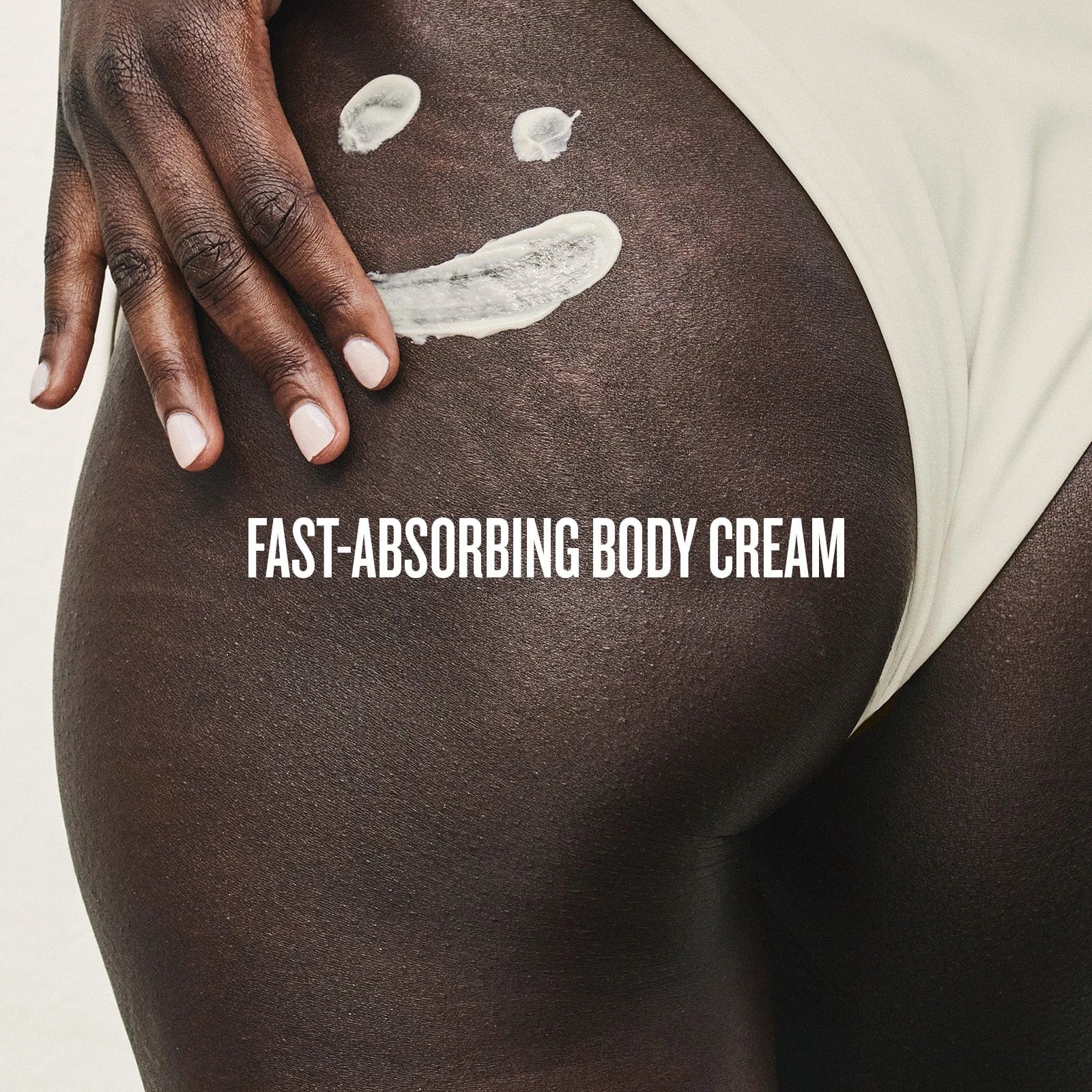 This image is showing Sol de Janeiro Brazilian Bum Bum Cream swiped on the side of a model&