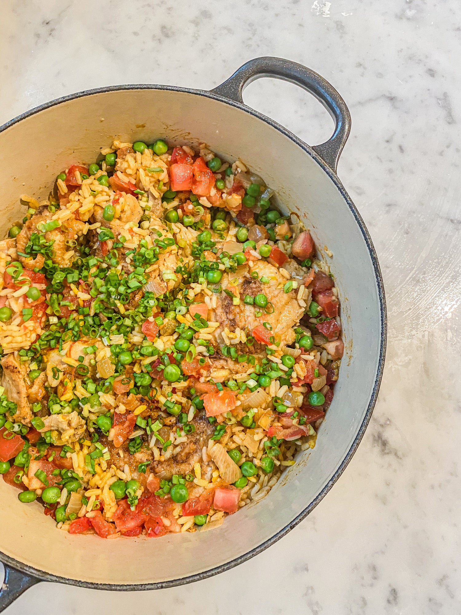 pot containing chicken, vegetables and rice