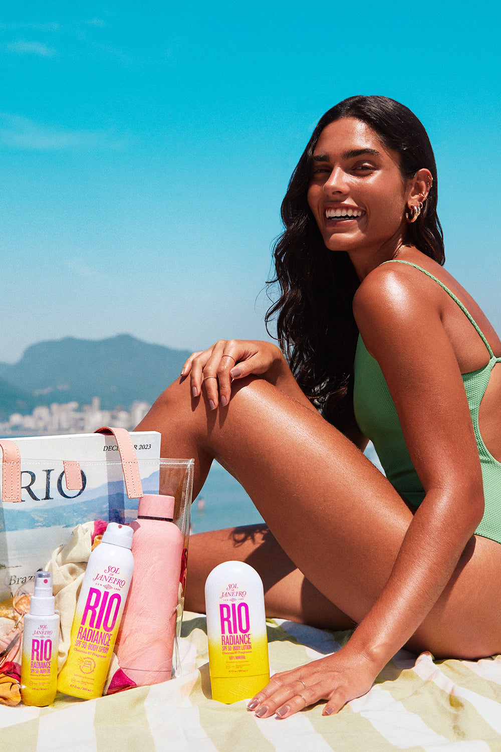 Model with SPF products in Rio - SPF 50 body oil, body spray and body lotion
