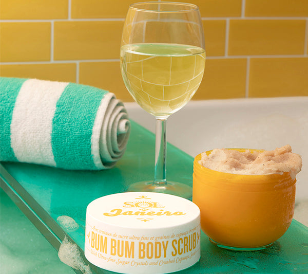 A glass of wine with Bum Bum Body Scrub | sol de janeiro