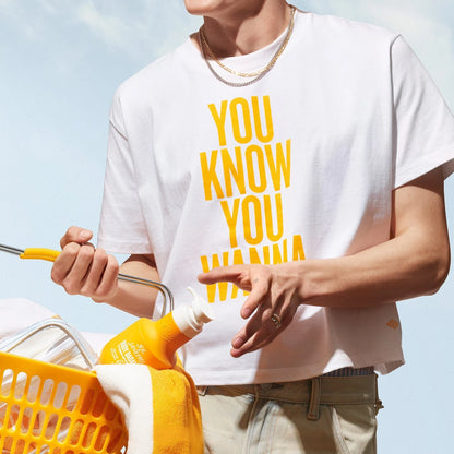 Another model wearing the sol de janeiro badalada t-shirt. T-shirt reads &quot;you know you wanna&